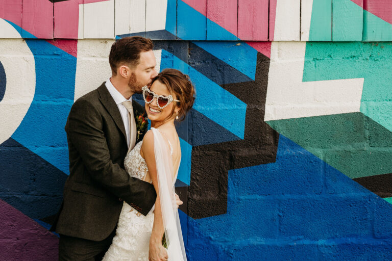 Bride and Groom in front of the mural at The Wholehouse by When Charlie Met Hannah