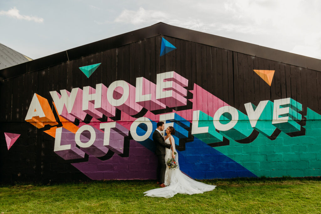 Bride and Groom in front of the mural at The Wholehouse by When Charlie Met Hannah