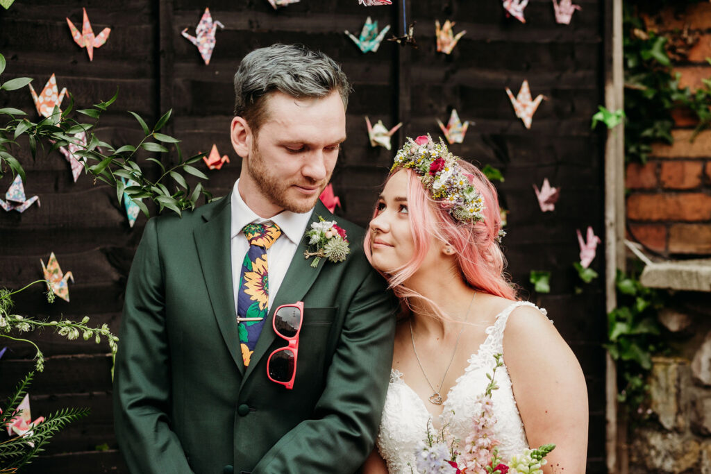 Bride and Groom looking sweetly at each other during their colourful, humanist wedding ceremony