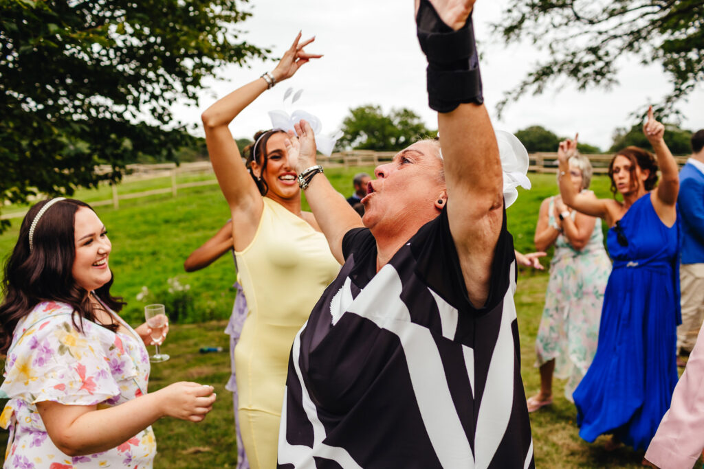 Wedding guests dancing wildly in a garden